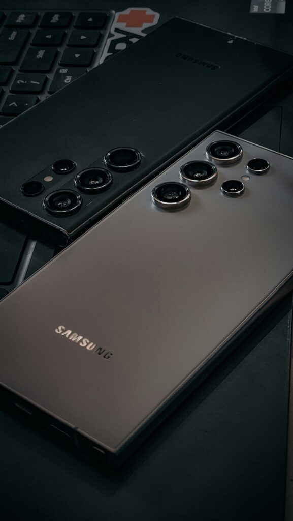 Two Samsung Galaxy S24 Ultra phones side by side on a laptop
