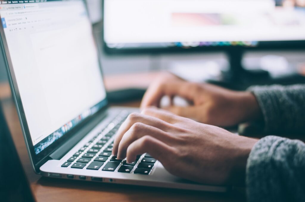 Hands typing on a Dell XPS laptop – productivity in focus