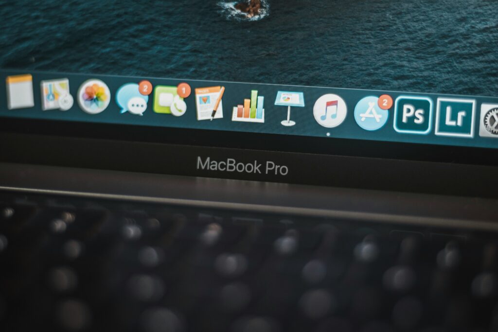 Close-up of MacBook Pro screen showing professional apps and workflow interface