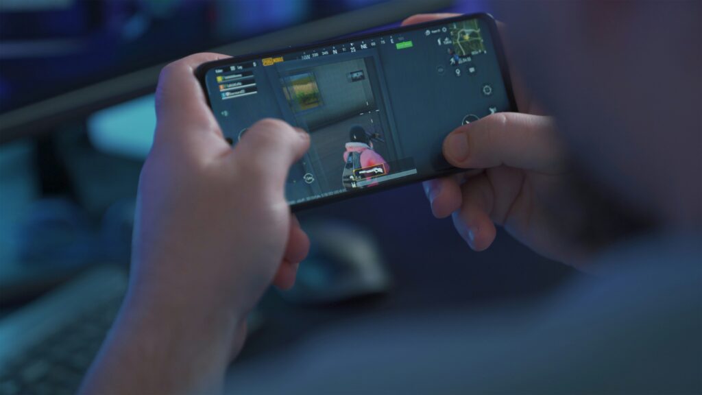 Close-up of person gaming on a smartphone using PUBG Mobile