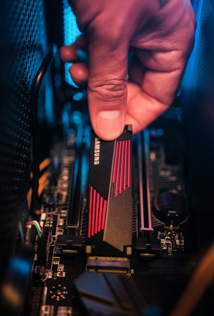 Hand installing Samsung NVMe SSD onto a gaming motherboard