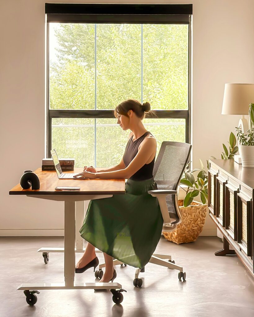Woman working in a clean, distraction-free home office setup with natural lighting