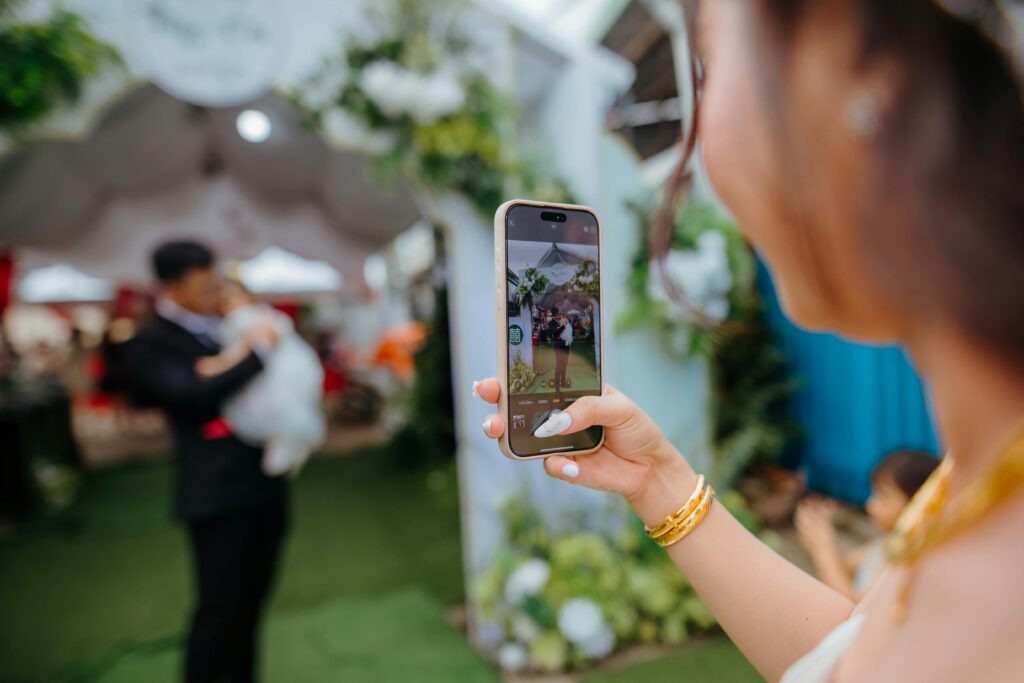 Woman using smartphone AI camera at event for photography