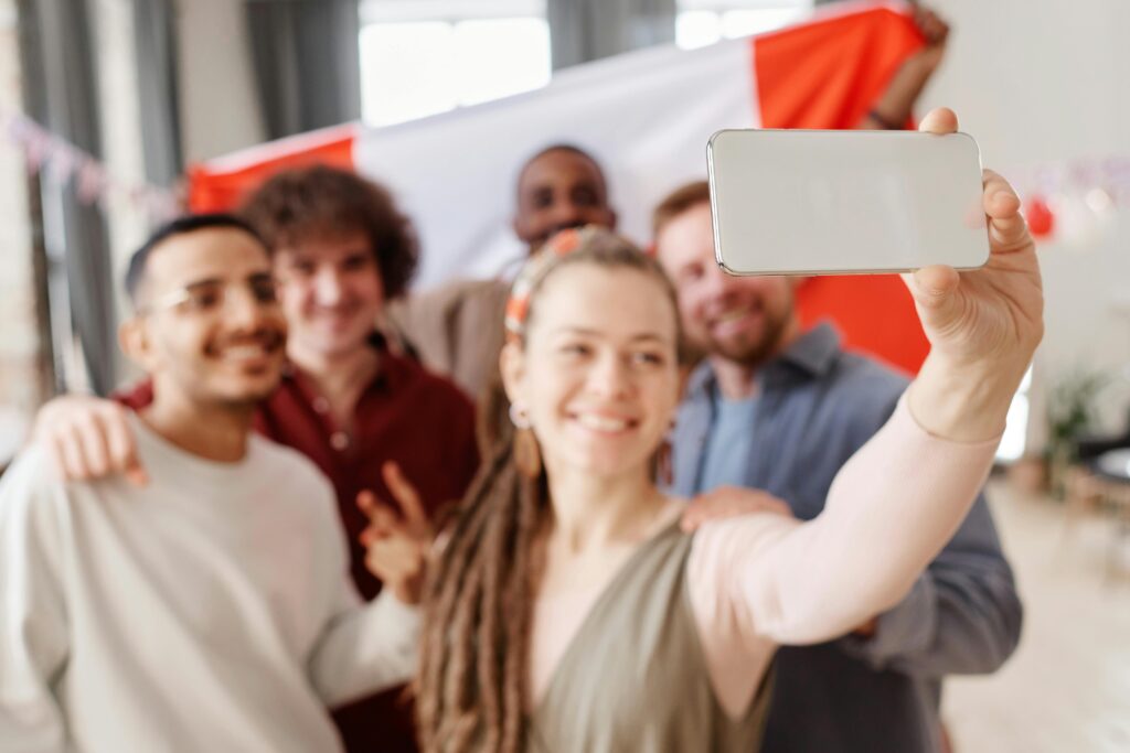 Friends taking a group selfie with smartphone AI camera features
