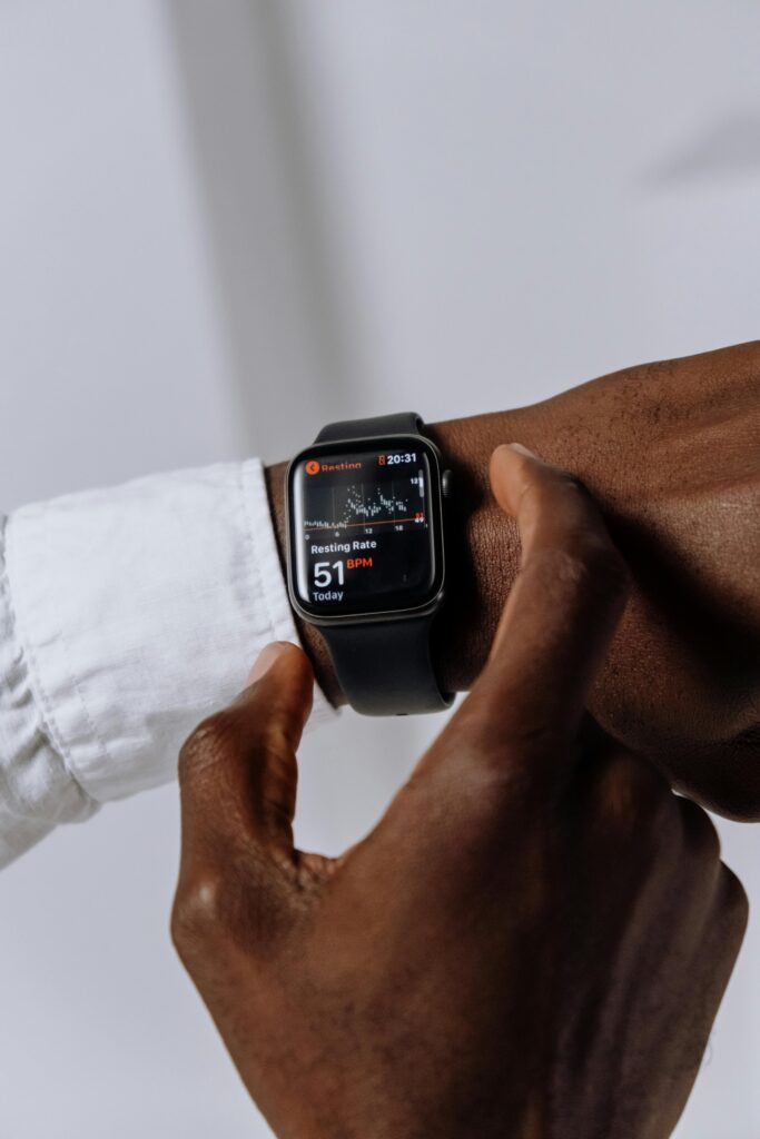 Man checking heart rate on a smartwatch — essential feature of the best fitness trackers in 2025 for health monitoring.
