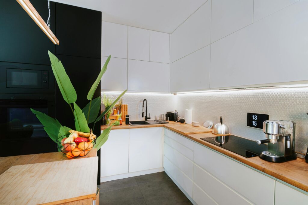 Stylish kitchen featuring integrated smart home appliances and digital assistants