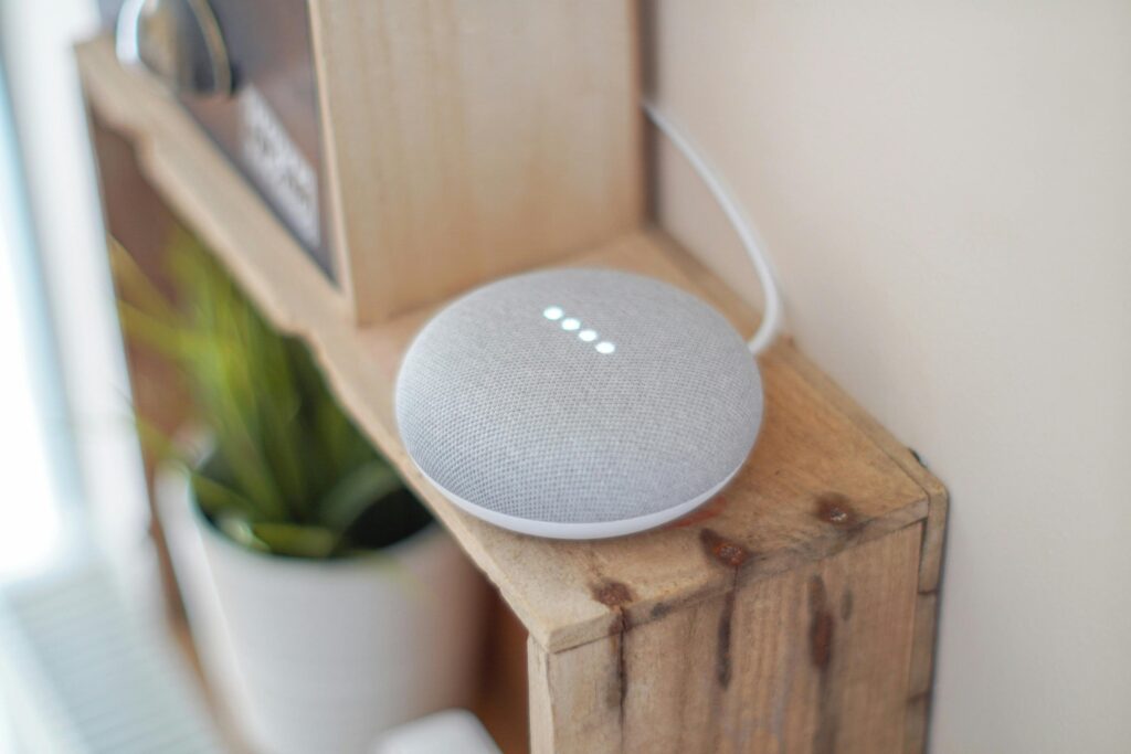 Voice-controlled smart speaker on a wooden surface
