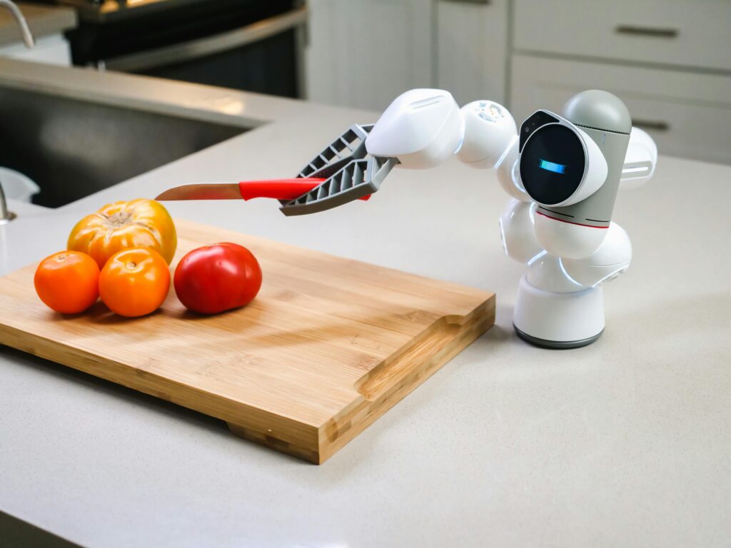 Smart robotic arm preparing vegetables in a modern kitchen setup