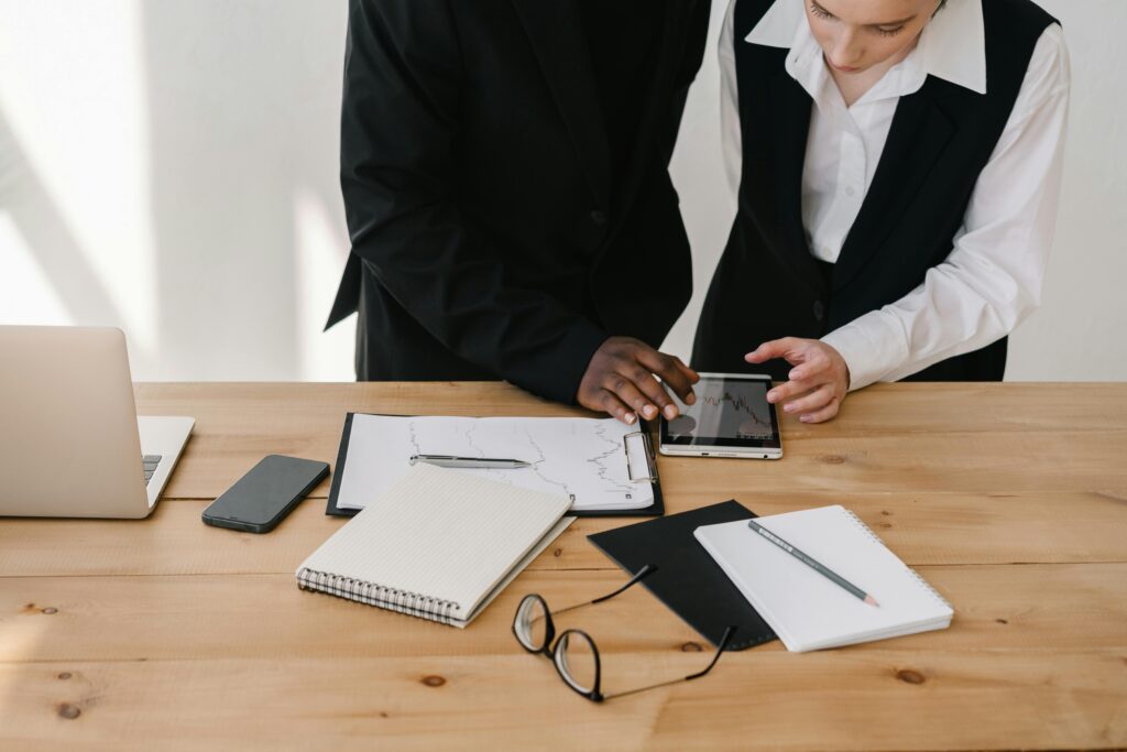 Office workers reviewing financial charts on a digital device